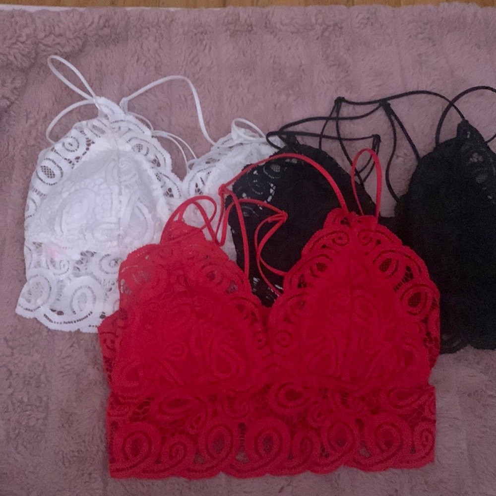 Set of Pink lace strappy bralettes in white, red, and black size small NWOT